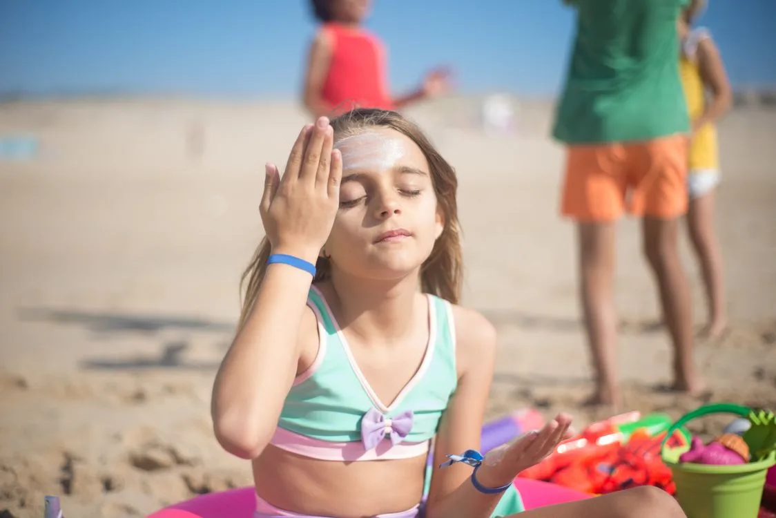 Person carefully applying sunscreen to their face